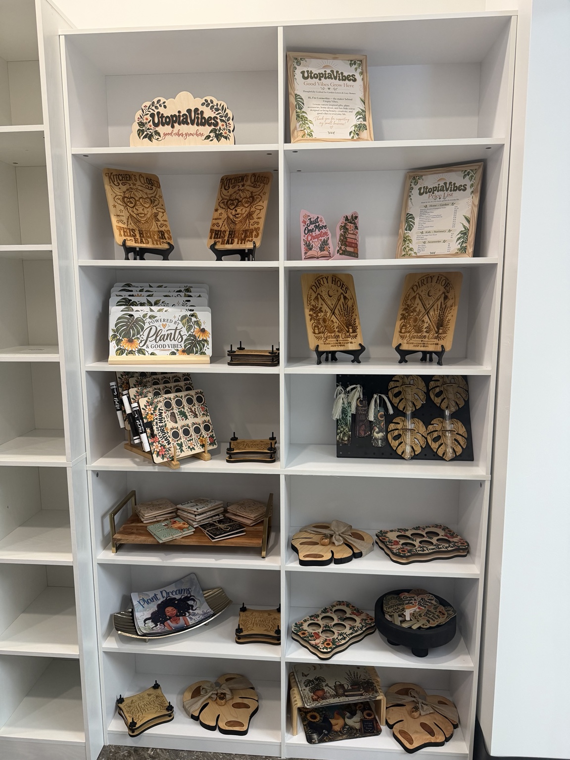 Utopia Vibes botanical gifts displayed on white shelves at Poplar and Payne