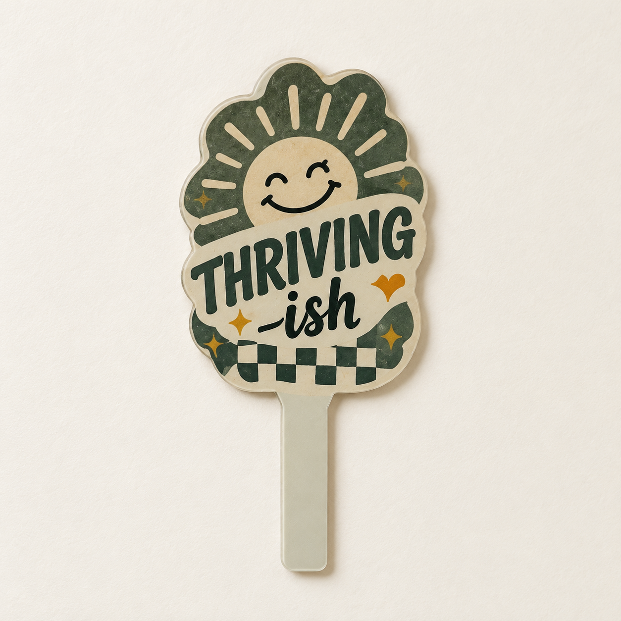 THRIVING-ish acrylic plant stake with a smiling sun and green checkerboard